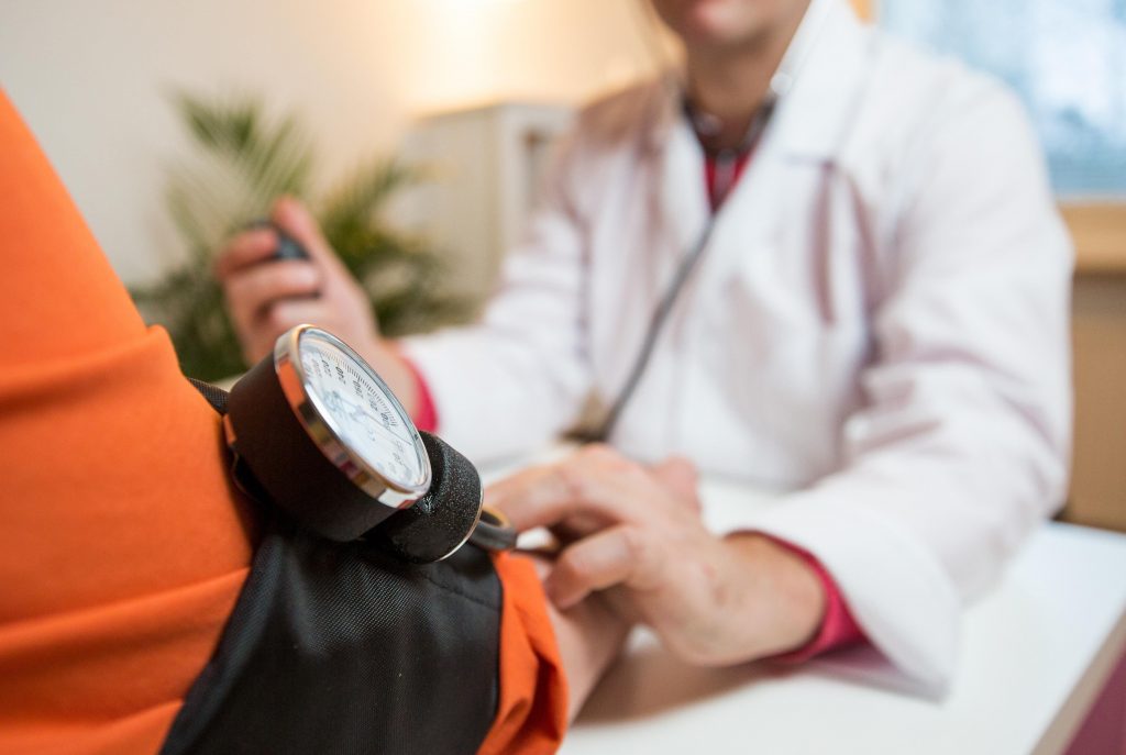 an image of a patient checking his blood pressure to reduce risk of having stroke 