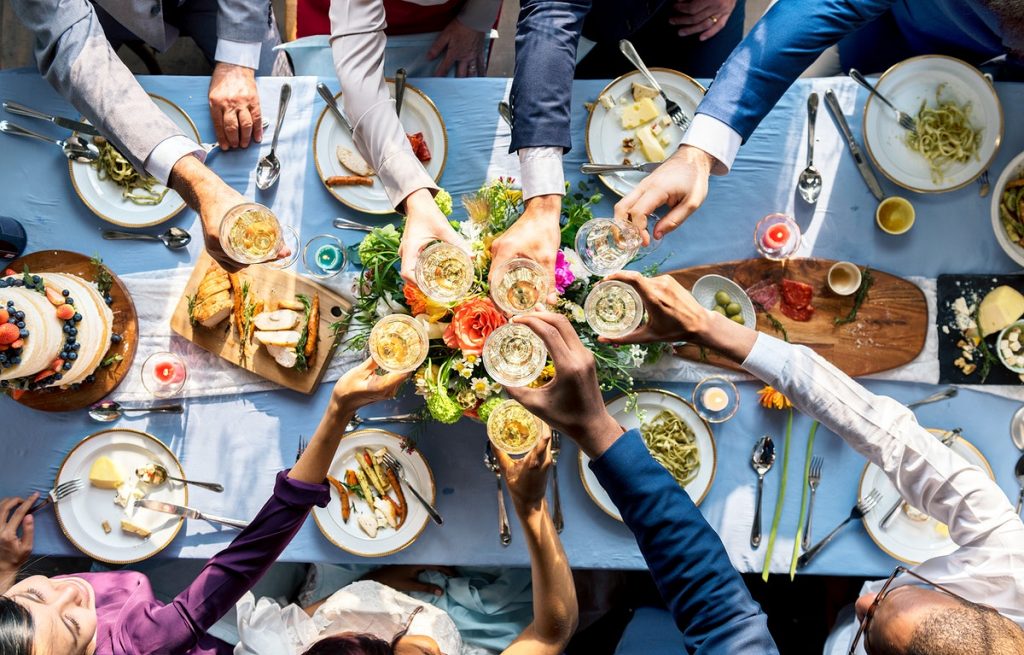 a table full of food and people overeating 