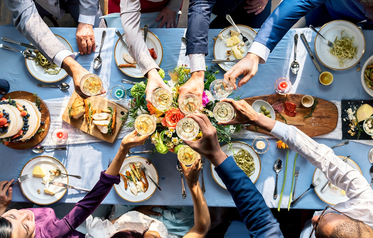 a table full of food and people overeating