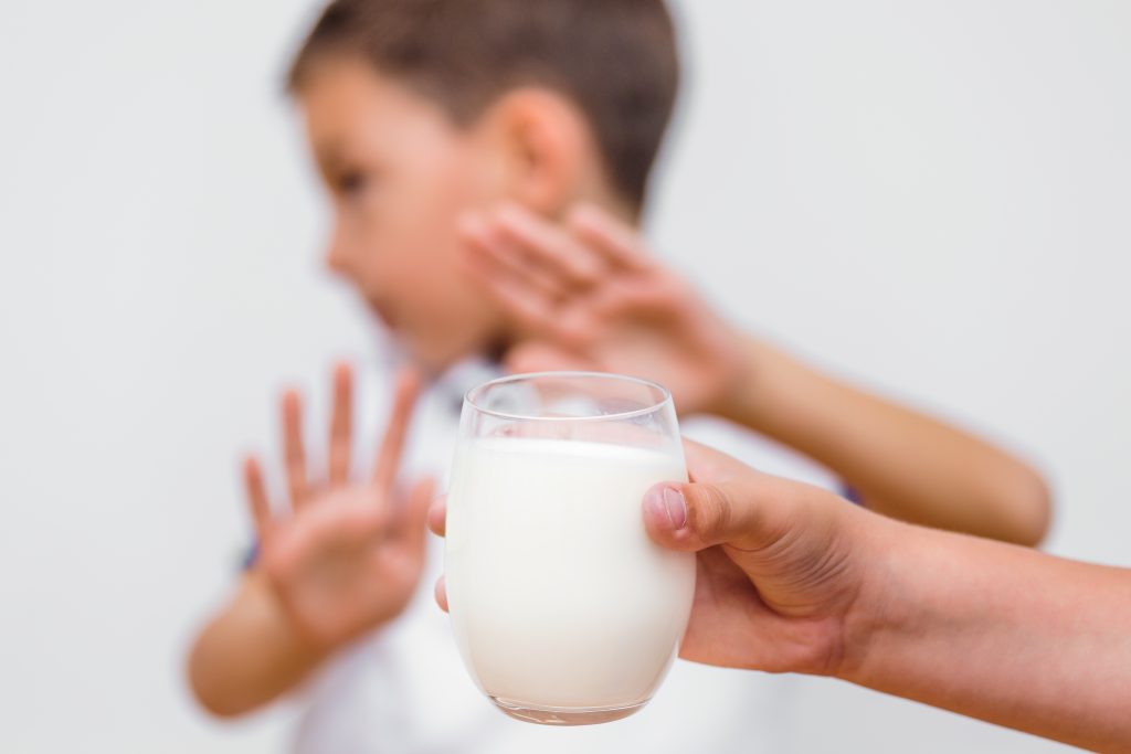 lactose intolerance in children blog image of a child refusing to drink milk